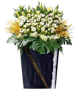 white gerbera and orchid grand funeral flower stand