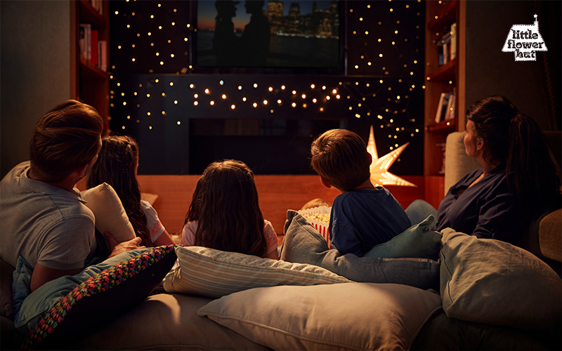 A family watching a movie at home during Christmas