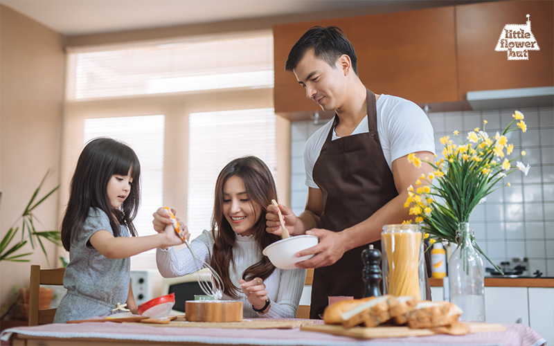 Parents baking some Christmas treats with their daughter 
