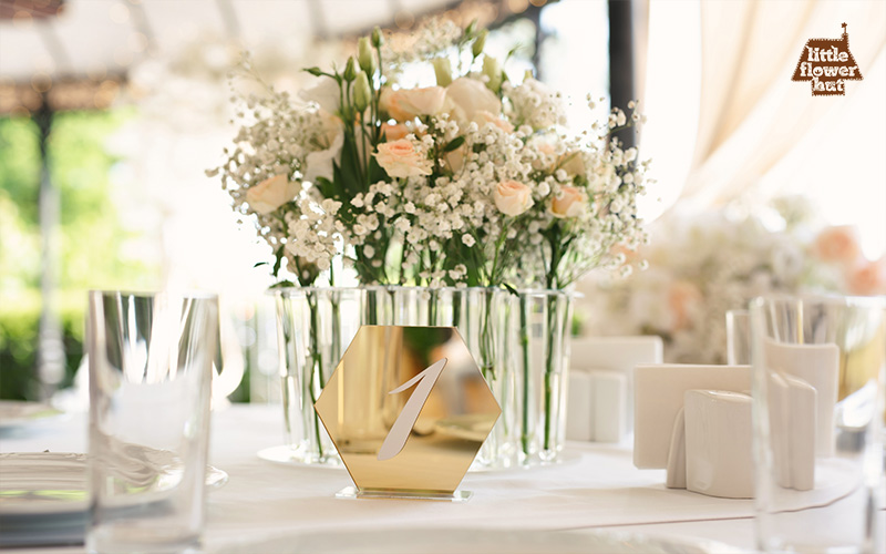Elegant wedding table with floral centerpiece and table number
