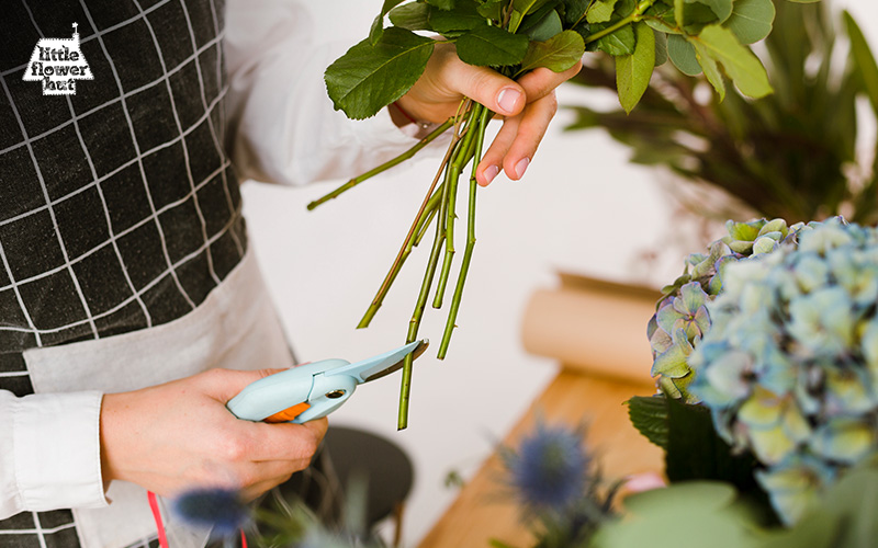 Florist cutting flower stems with a pruning shear